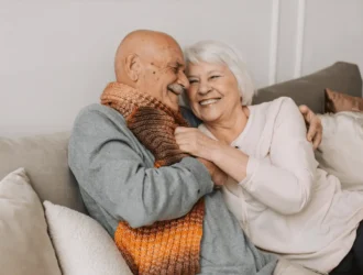 Older couple smiling together, sharing a warm and affectionate moment, highlighting the joy of aging and the importance of dental health