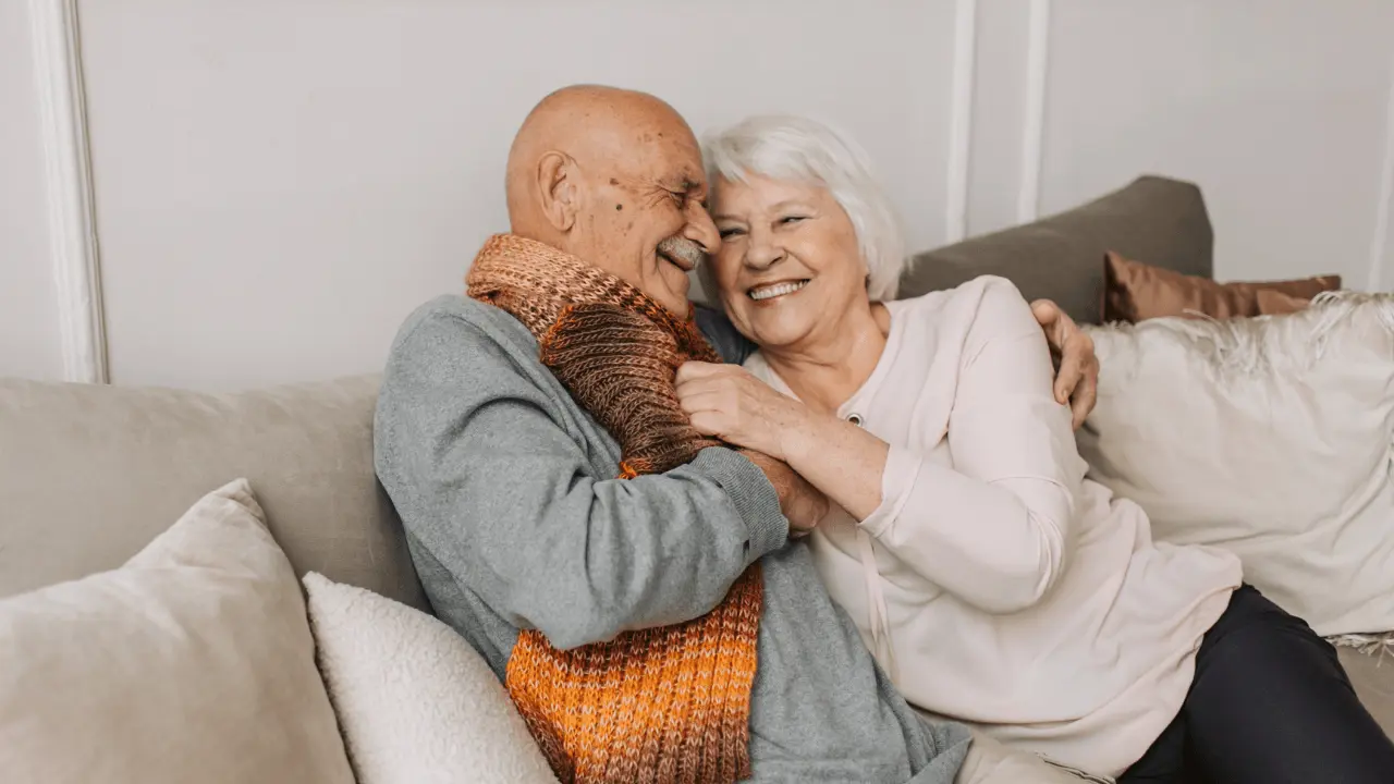 Older couple smiling together, sharing a warm and affectionate moment, highlighting the joy of aging and the importance of dental health