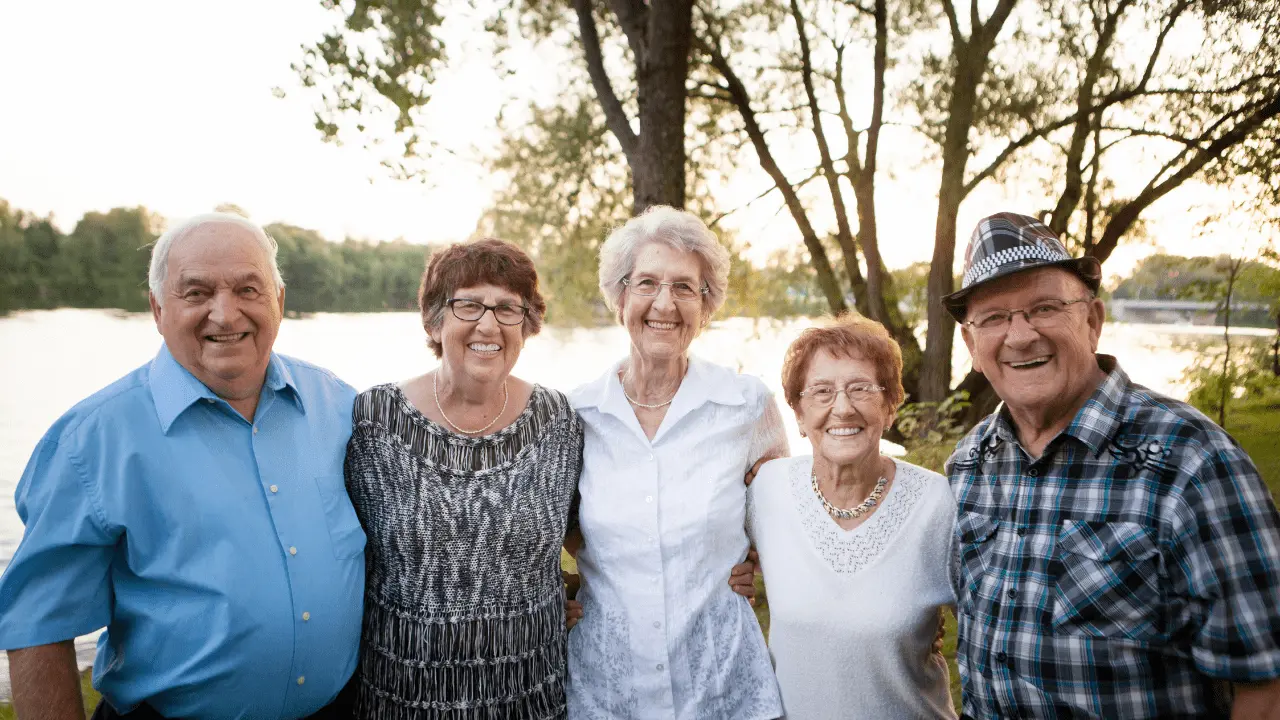 Group of seniors standing outdoors, showcasing diverse senior picture ideas with natural backgrounds