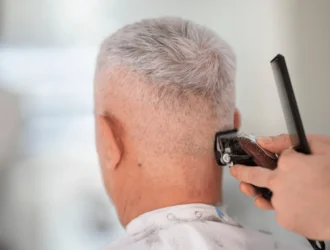 Senior man getting a stylish short haircut at the barber shop