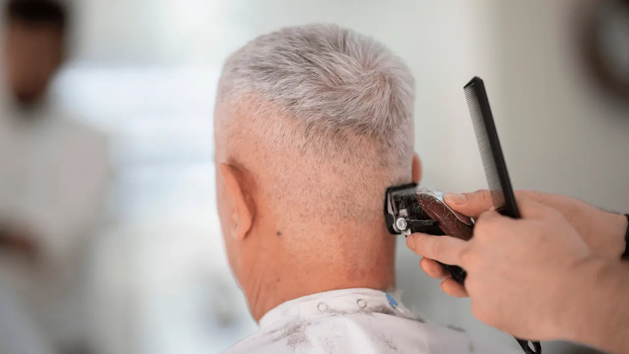 Senior man getting a stylish short haircut at the barber shop