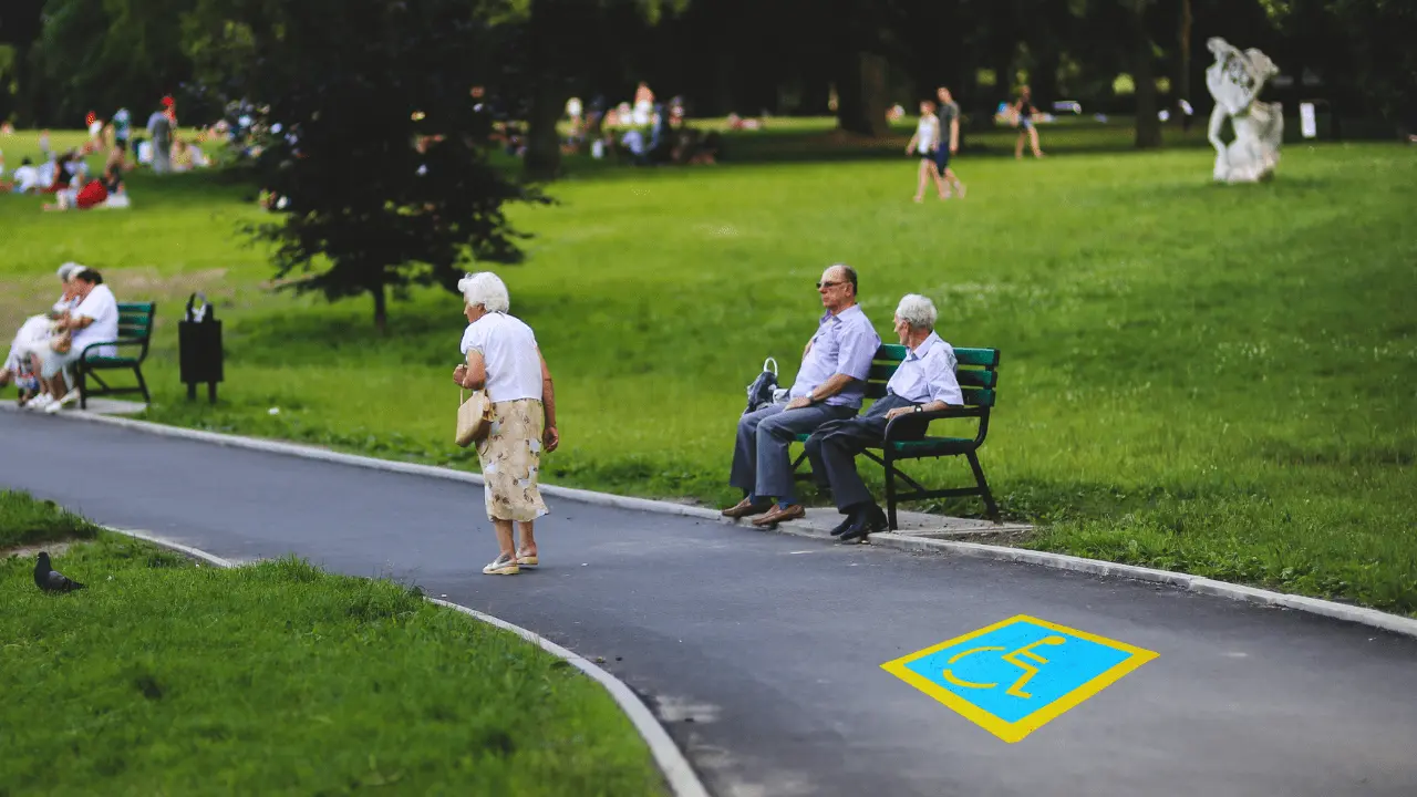 Senior citizens walking in the park with a blue handicapped parking symbol on the path, representing senior parking spot ideas