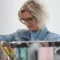 Senior woman shopping for clothes, looking at colorful garments in a clothing store, enjoying a shopping experience with discounts for seniors