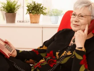 Senior woman using a landline phone at home, enjoying a conversation with clear sound and ease